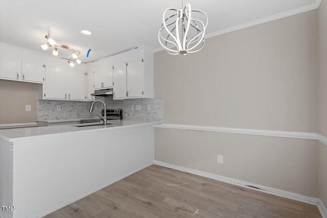 kitchen with sink, crown molding, light wood-type flooring, pendant lighting, and white cabinets