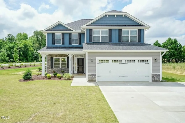 craftsman-style home featuring a garage and a front lawn