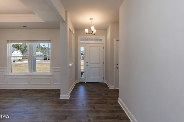 foyer featuring dark hardwood / wood-style floors and a chandelier