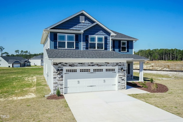 view of front of home with a garage and a front yard