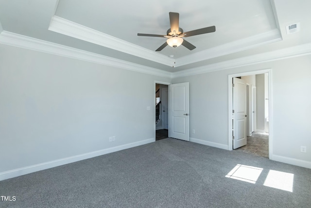 unfurnished bedroom featuring a raised ceiling, crown molding, light colored carpet, and ceiling fan