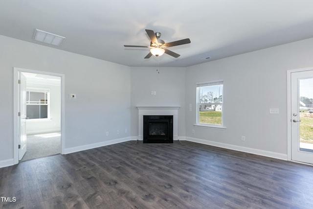 unfurnished living room featuring ceiling fan and dark hardwood / wood-style flooring