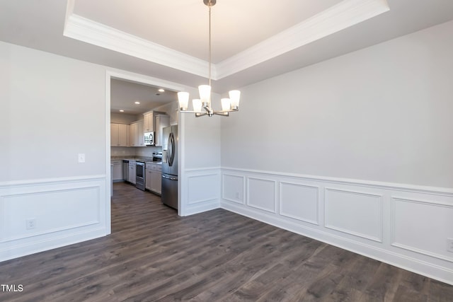 unfurnished dining area with crown molding, dark hardwood / wood-style floors, a raised ceiling, and a notable chandelier