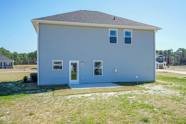 rear view of property with a patio and a lawn