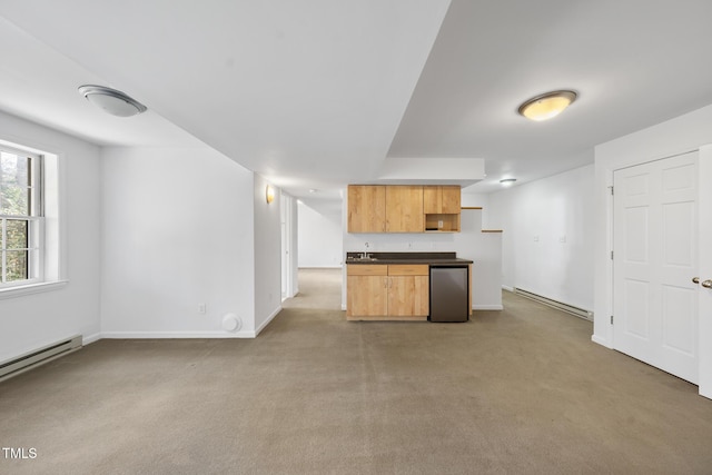 kitchen featuring light carpet, baseboard heating, dark countertops, and refrigerator