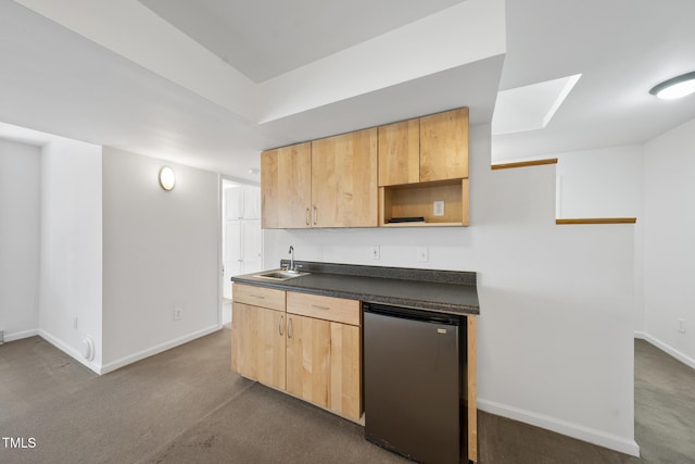 kitchen with baseboards, dark countertops, refrigerator, open shelves, and a sink