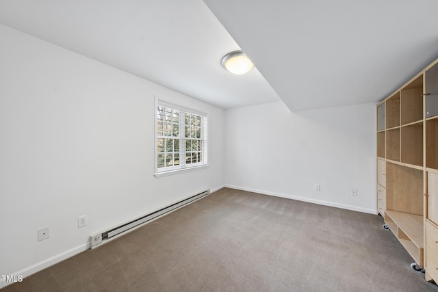 carpeted empty room with a baseboard heating unit and baseboards