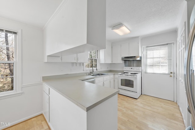 kitchen with light countertops, white electric range, a sink, a peninsula, and under cabinet range hood