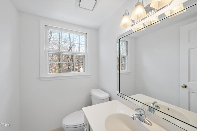 half bathroom featuring toilet and vanity