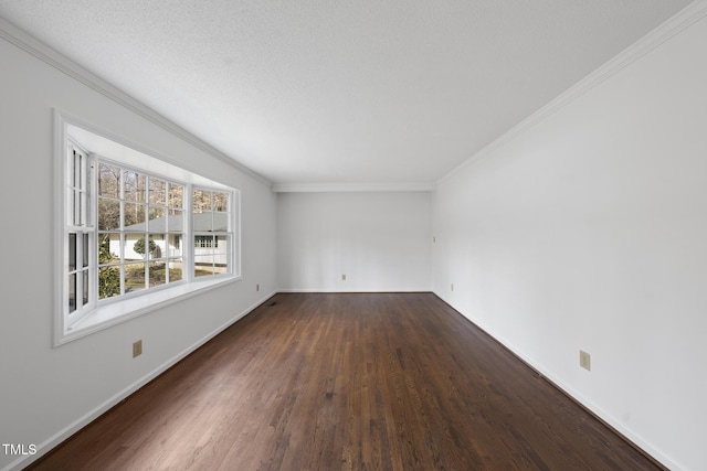 spare room with baseboards, a textured ceiling, wood finished floors, and crown molding