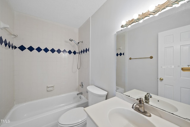 full bathroom with tub / shower combination, a textured ceiling, toilet, and vanity