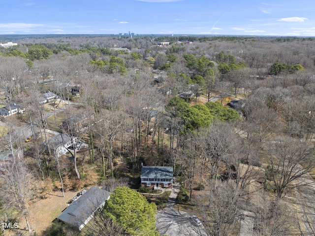 drone / aerial view with a wooded view