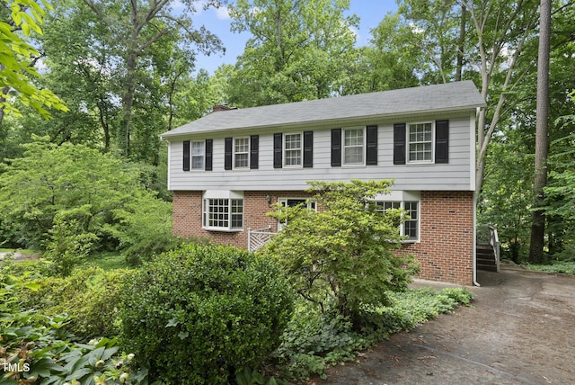 2004 Beecham Cir, Raleigh, NC 27607 - colonial-style house with brick siding and a chimney