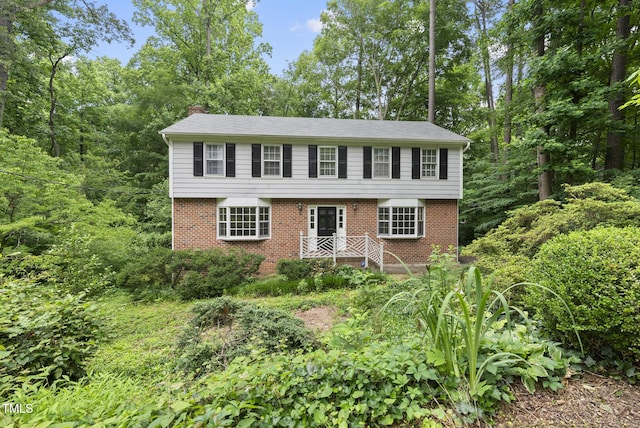2004 Beecham Cir, Raleigh, NC 27607 - colonial inspired home featuring a chimney and brick siding