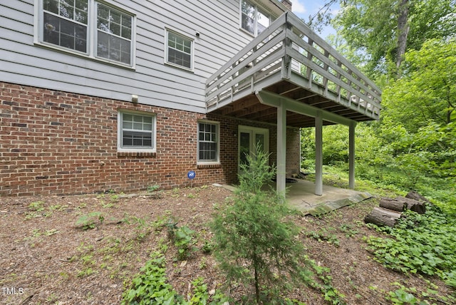 2004 Beecham Cir, Raleigh, NC 27607 - view of side of property featuring a patio, brick siding, and a deck