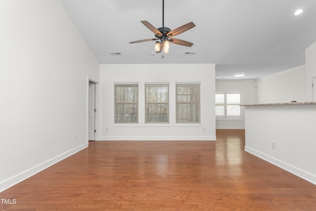 unfurnished living room featuring hardwood / wood-style floors and ceiling fan