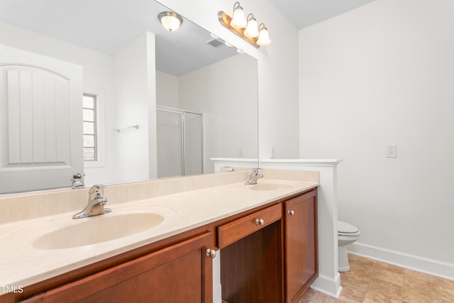 bathroom with vanity, toilet, and a shower with shower door