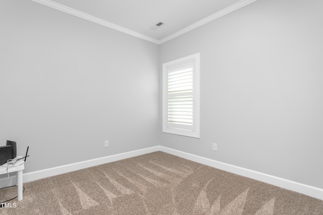 spare room with ornamental molding and carpet