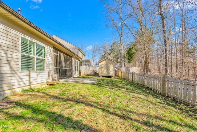 view of yard featuring a storage shed, a sunroom, and a patio