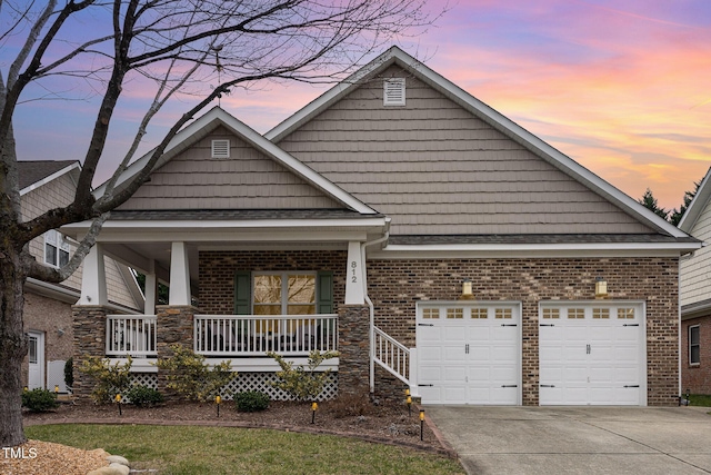 craftsman-style house with a garage and covered porch