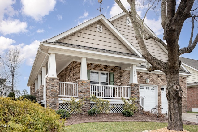 craftsman inspired home featuring a garage and covered porch