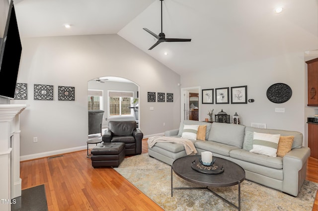 living room with high vaulted ceiling, hardwood / wood-style floors, and ceiling fan