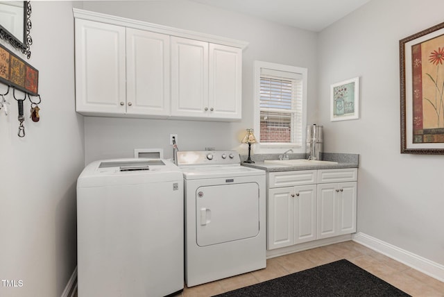 clothes washing area featuring independent washer and dryer, cabinets, sink, and light tile patterned floors