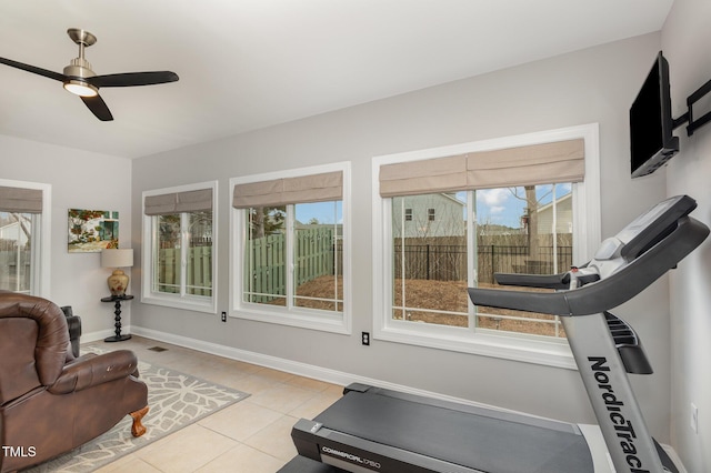 workout area featuring ceiling fan and light tile patterned floors