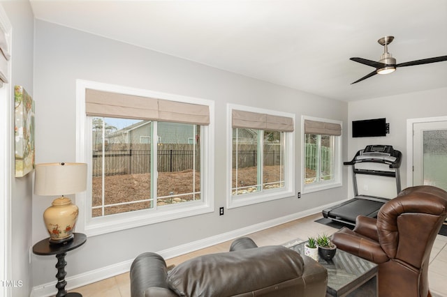 workout room featuring a healthy amount of sunlight and ceiling fan