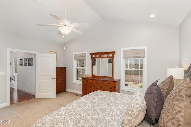 carpeted bedroom with ceiling fan and vaulted ceiling