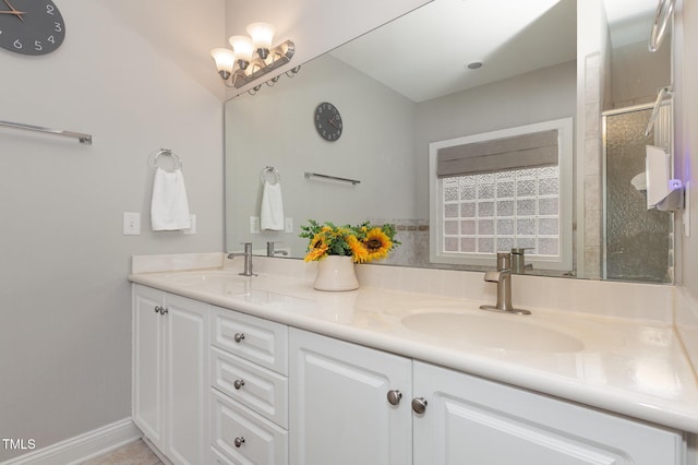 bathroom featuring vanity and a shower with door