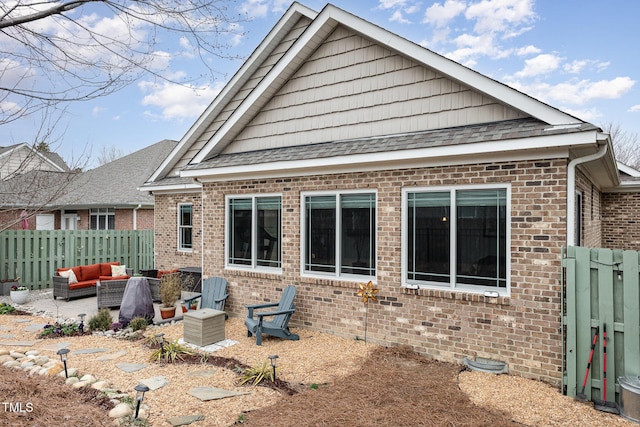 back of property featuring a patio and outdoor lounge area