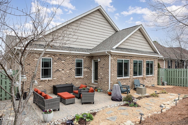 back of house with outdoor lounge area and a patio area