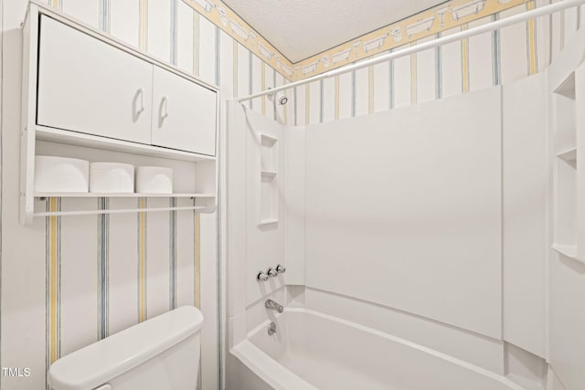 bathroom with shower / washtub combination, a textured ceiling, and toilet