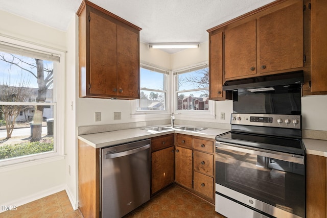 kitchen with a healthy amount of sunlight, stainless steel appliances, and sink