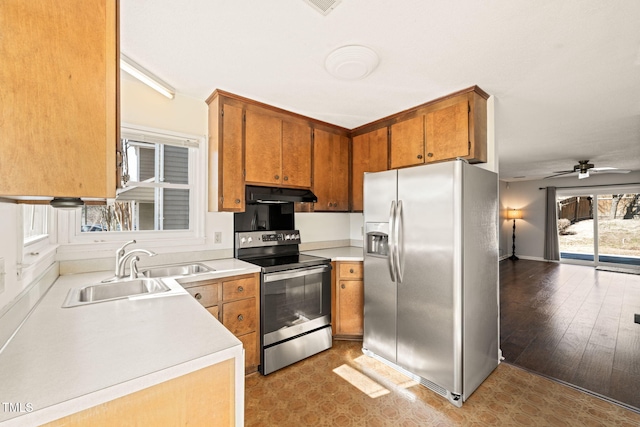 kitchen featuring ceiling fan, stainless steel appliances, and sink