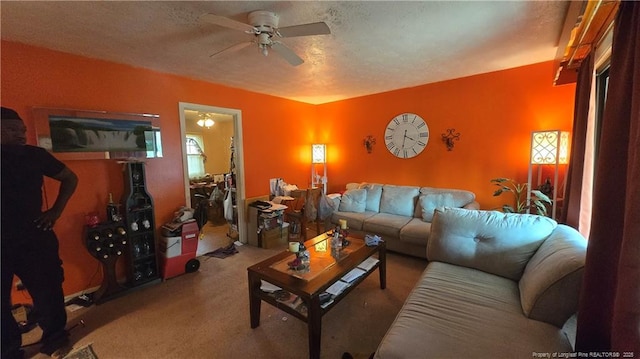 carpeted living room with ceiling fan and a textured ceiling