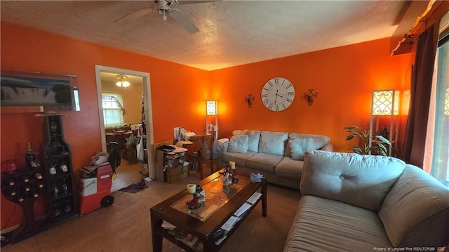 carpeted living room with ceiling fan