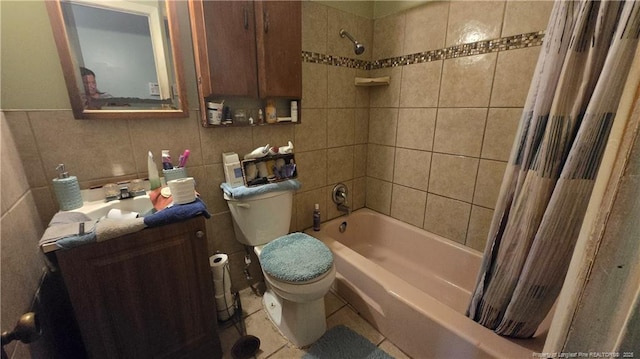 full bathroom featuring shower / tub combo with curtain, tile patterned flooring, tile walls, vanity, and toilet