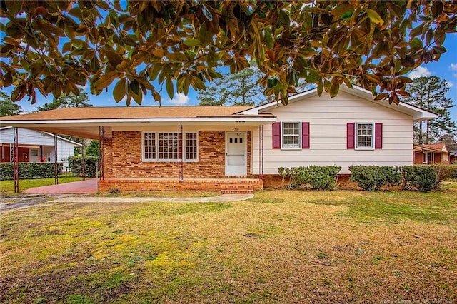 view of front of property with a carport and a front lawn