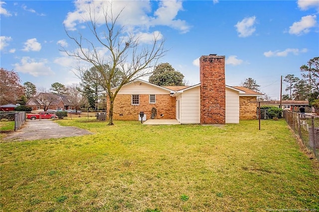 back of house featuring a patio and a lawn