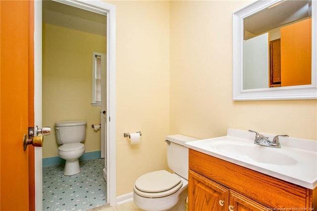 bathroom with vanity, tile patterned flooring, and toilet