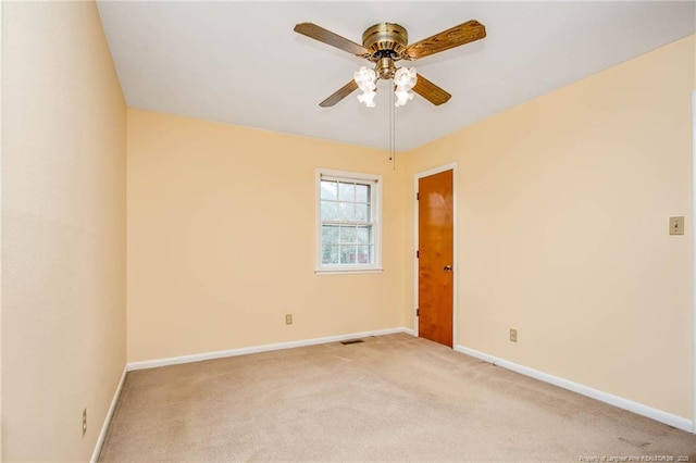 spare room with light carpet and ceiling fan