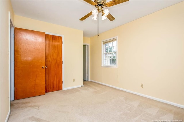 unfurnished bedroom with light carpet and ceiling fan