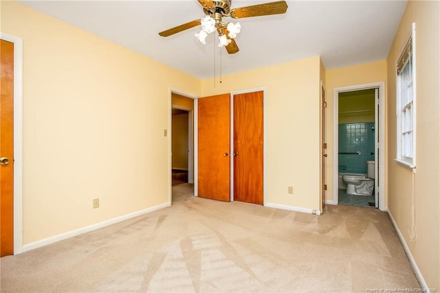 unfurnished bedroom with ensuite bathroom, light carpet, ceiling fan, and a closet