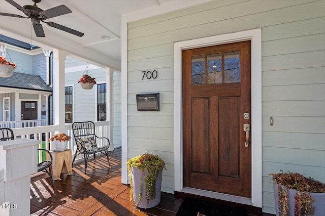 doorway to property with ceiling fan and covered porch