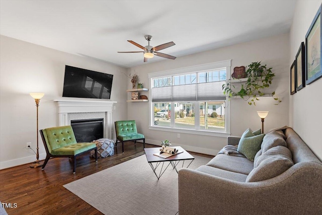 living room with ceiling fan and dark hardwood / wood-style floors