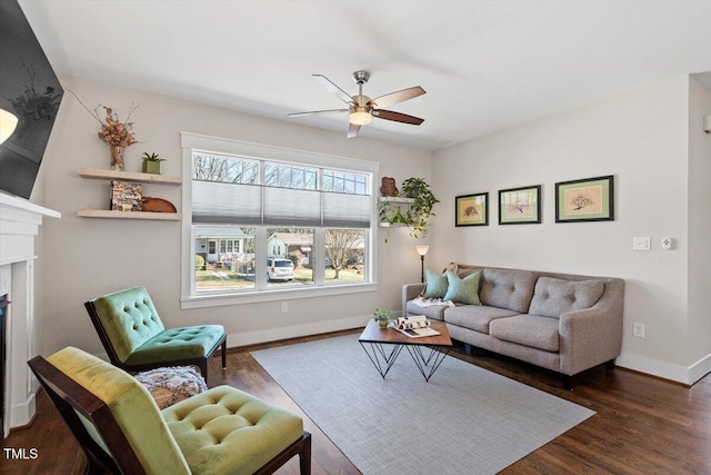 living room featuring ceiling fan and dark hardwood / wood-style flooring