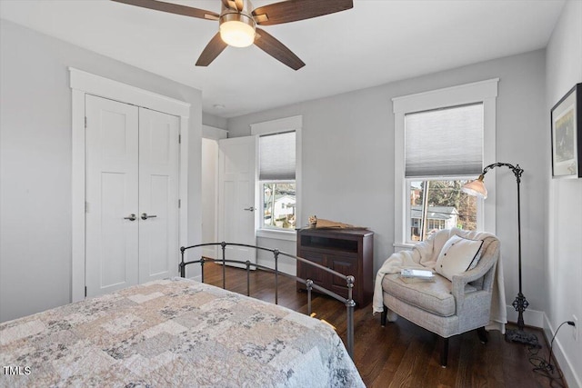 bedroom featuring a closet, dark hardwood / wood-style floors, and ceiling fan