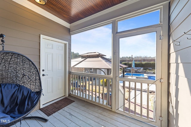 deck with a gazebo and an outdoor pool